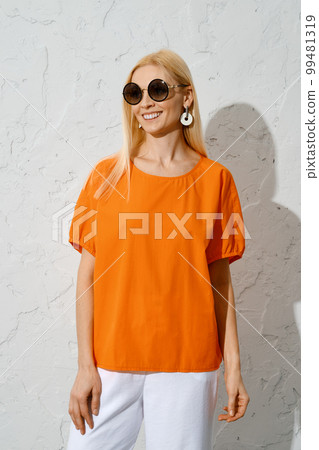 Smiling adult woman in bright summer outfit 99481319