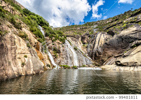 Ezaro waterfall, Galicia, Northern Spain in Spring. It empties into the Atlantic ocean in a waterfall Ezaro waterfall, Galicia, Northern Spain in Spring. It empties into the Atlantic ocean in a waterfall 99481811