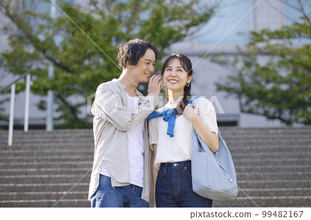 Young couple walking arm in arm Young couple walking arm in arm 99482167