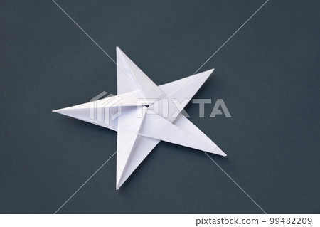 White paper star origami isolated on a grey background 99482209