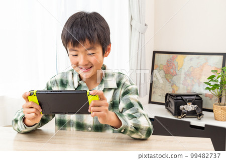 boy playing games in children's room 99482737