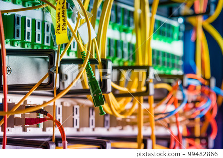 detail of server rack with fiber optic cables attached to front panel switch ports detail of server rack with fiber optic cables attached to front panel switch ports 99482866
