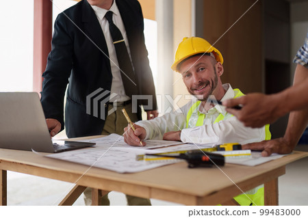 Civil Construction team working at renovate construction site. architectural plan, engineer sketching a construction project, green energy concept. Civil Construction team working at renovate construction site. architectural plan, engineer sketching a construction project, green energy concept. 99483000