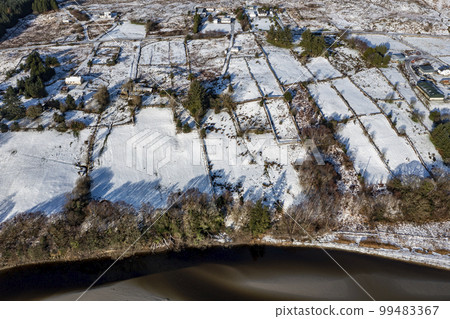 Aerial view of snow covered Gweebarra River between Doochary and Lettermacaward in Donegal - Ireland 99483367
