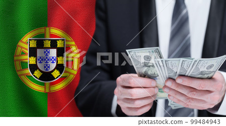 Hands holding dollar money on flag of Portugal 99484943