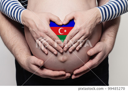 Azerbaijani family concept. Man embracing pregnant woman belly and heart with flag  99485270