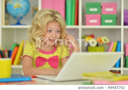 girl using laptop at desk at home girl using laptop at desk at home 99485702