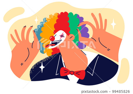 Clown sticks out tongue and makes funny faces to audience laugh at humorous theatrical performance 99485826