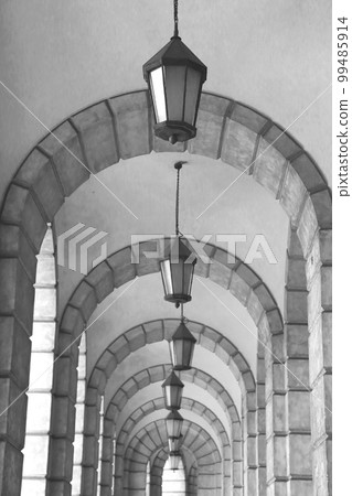 The arched stone colonnade with lanterns concept photo. Urban architectural photography. The arched stone colonnade with lanterns concept photo. Urban architectural photography. 99485914