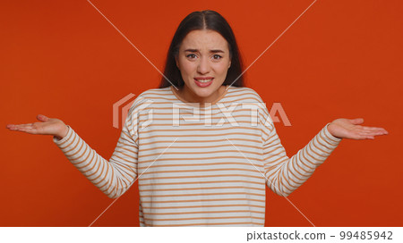 Woman raising hands in indignant expression ask why what reason of failure demonstrating disbelief Woman raising hands in indignant expression ask why what reason of failure demonstrating disbelief 99485942
