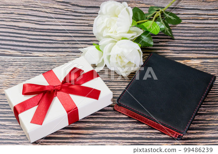Gifts, wallets and white roses 99486239
