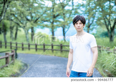 A half man strolling through a fresh green park 99486777