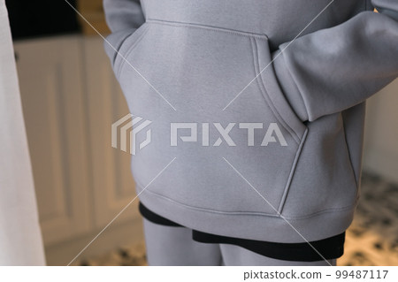 Close up of detail sweatshirt or hoodie - fabric and tailoring clothes design concept Close up of detail sweatshirt or hoodie - fabric and tailoring clothes design concept 99487117