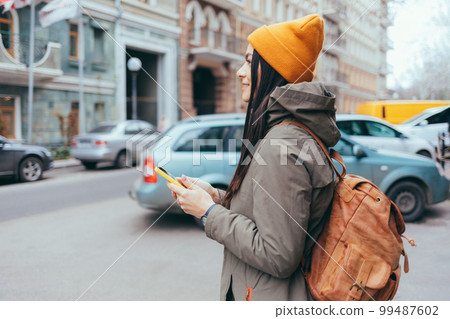 Young woman tourist with a backpack Young woman tourist with a backpack 99487602