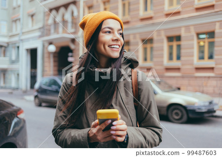 Attractive young woman tourist talking on mobile phone Attractive young woman tourist talking on mobile phone 99487603