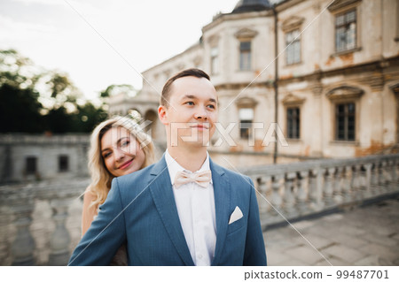 Romantic wedding moment, couple of newlyweds smiling portrait, bride and groom hugging Romantic wedding moment, couple of newlyweds smiling portrait, bride and groom hugging 99487701