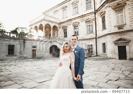 Romantic wedding moment, couple of newlyweds smiling portrait, bride and groom hugging Romantic wedding moment, couple of newlyweds smiling portrait, bride and groom hugging 99487715