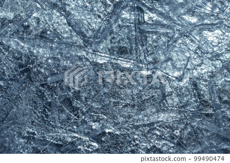 Shiny blue ice surface, macro pattern, natural background texture 99490474