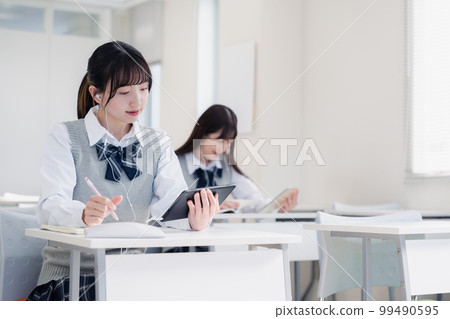 High school students taking classes on tablet devices 99490595