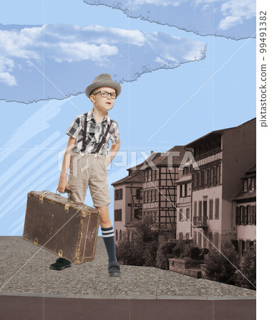 Contemporary art collage. Creative abstract design. Little boy, child with vintage suitcase standing near building. Traveller. 99491382