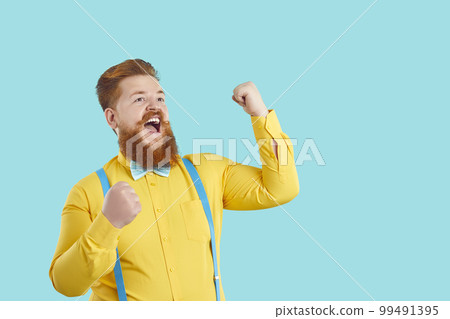 Happy excited funny chubby young man celebrating success, shouting YES and having fun 99491395