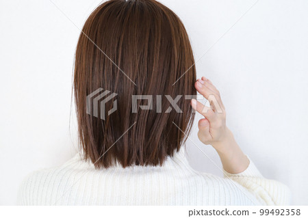 Woman touching her hair Hair care image 99492358