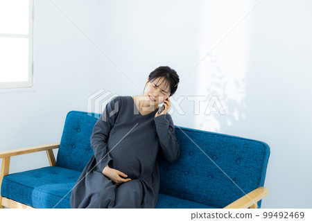 Pregnant woman living room Pregnant woman living room 99492469