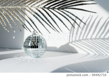 Disco ball in sunlight on white background Disco ball in sunlight on white background 99492716
