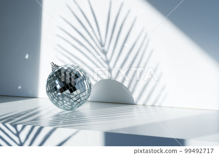 Disco ball in sunlight on white background Disco ball in sunlight on white background 99492717