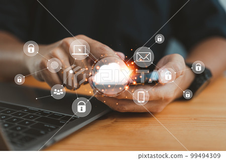 businessman in an office working on his smartphone and selecting the cloud icon on a virtual display. This symbolizes the use of digital technology and cloud technology. businessman in an office working on his smartphone and selecting the cloud icon on a virtual display. This symbolizes the use of digital technology and cloud technology. 99494309