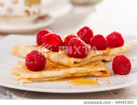 delicious pancakes with fresh raspberries and honey delicious pancakes with fresh raspberries and honey 99495305