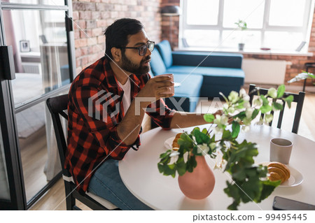 Couple drinking a morning coffee together. Man talks with her wife - lifestyle and communication family concept 99495445