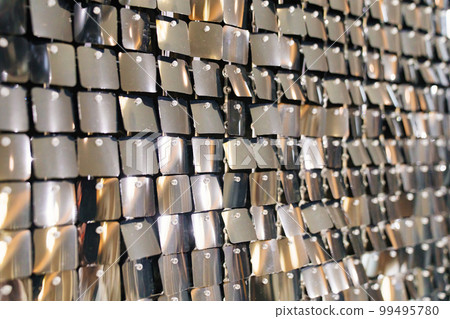 wall with sequins. iridescent and shiny plates as a decor. wall with sequins. iridescent and shiny plates as a decor. 99495780