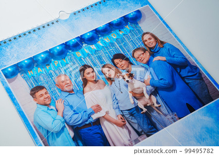 a flip calendar with family photos with dog. a flip calendar with family photos with dog. 99495782