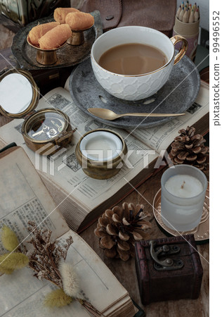 Hot coffee in ceramic cup and Fresh milk served with Sweet egg floss on old wooden worktable. 99496552