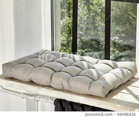 Soft Scandinavian style gray cushion lying on windowsill 99496836
