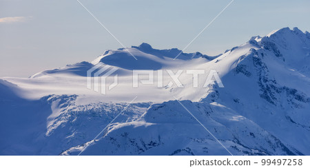 Snow and Cloud covered Canadian Nature Landscape Mountains Background. Whistler Snow and Cloud covered Canadian Nature Landscape Mountains Background. Whistler 99497258