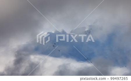 Tantalus Range covered in Snow and Clouds during Winter Season. Tantalus Range covered in Snow and Clouds during Winter Season. 99497265