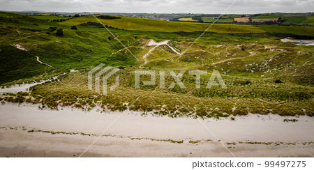 Picturesque sand hills of Ireland, top view. Sand dunes covered with vegetation. Irish landscape. 99497275