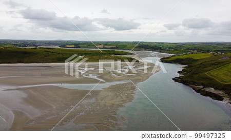 Inchydoney Beach on a cloudy summer day, top view. Seaside landscape. The famous Irish sandy beach. The coastline of the Atlantic Ocean. 99497325