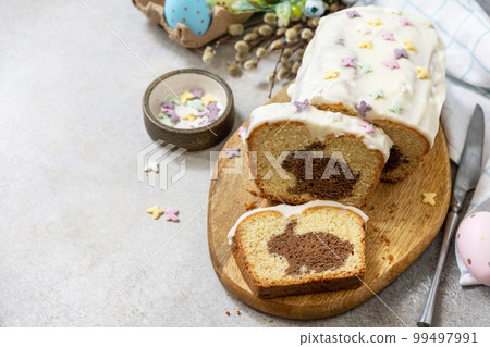 Happy Easter holiday food baking, cupcake with Easter Bunny and colorful eggs on stone background. Copy space. 99497991