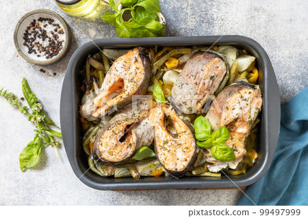 Seafood. Recipe. Healthy baked fish salmon steaks with basil, green beans, sweet peppers and onions. Cooking a delicious low carb dinner, healthy nutrition concept, diet menu. View from above. 99497999