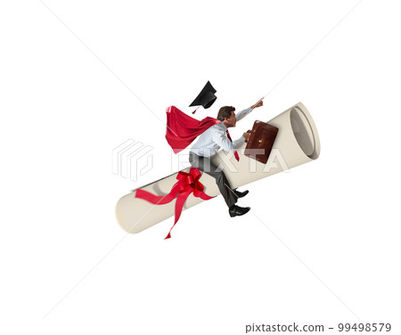 Young graduate boy rides a graduation parchment 99498579