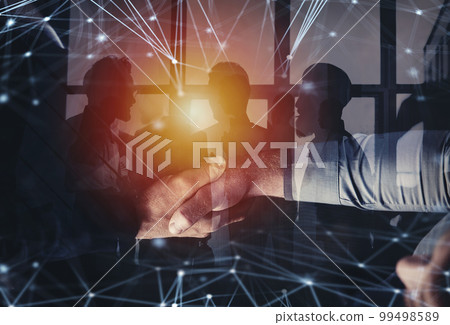 Handshaking business person in office with network effect. concept of teamwork and partnership. double exposure 99498589