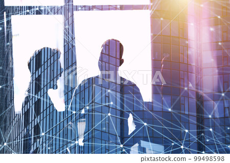 Business people work together in office with internet network effects. Concept of teamwork and partnership. double exposure 99498598
