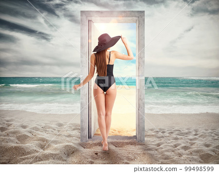 Woman crosses a door on the beach leading to the summer season. Woman crosses a door on the beach leading to the summer season. 99498599