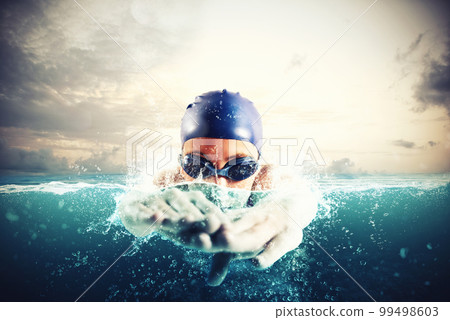 Athlete swims in a blue deep water 99498603