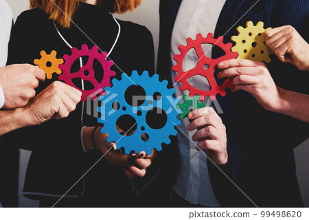 Business team connect pieces of gears. Teamwork, partnership and integration concept 99498620