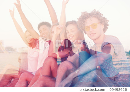Group of happy friends having fun at ocean beach. double exposure Group of happy friends having fun at ocean beach. double exposure 99498626