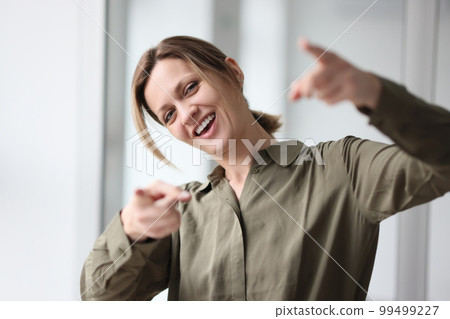 Portrait laughing woman showing index fingers, close-up 99499227